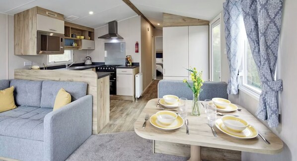 A modern kitchen with a stove, oven, and built-in cabinets.