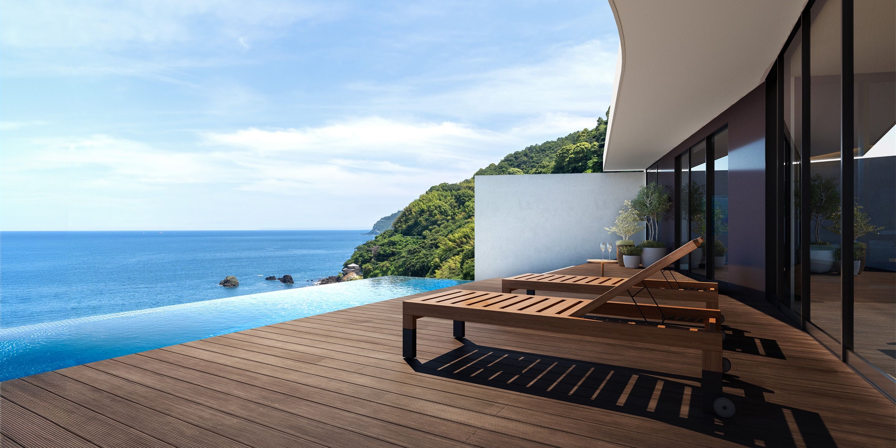 Terraza de madera con piscina y vistas al paisaje costero.