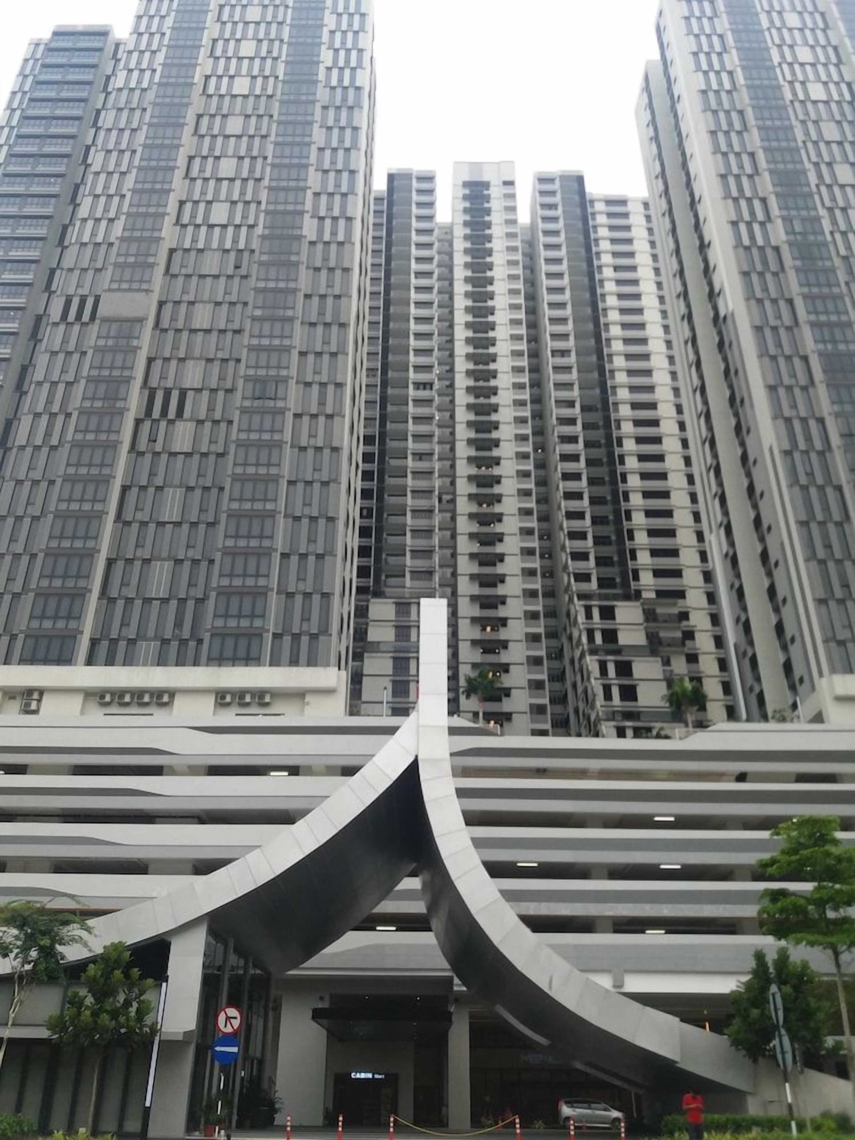 A modern building with a curved entrance and multiple floors.