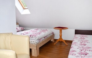 A bedroom with a bed, a chair, a small table, and a window. - 2 bedroom awesome home in Oslonka (Oslonka)
