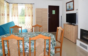 A room with a bed, two chairs, a television, a cabinet, and a door. - 2 bedroom stunning home in Oslonka (Oslonka)