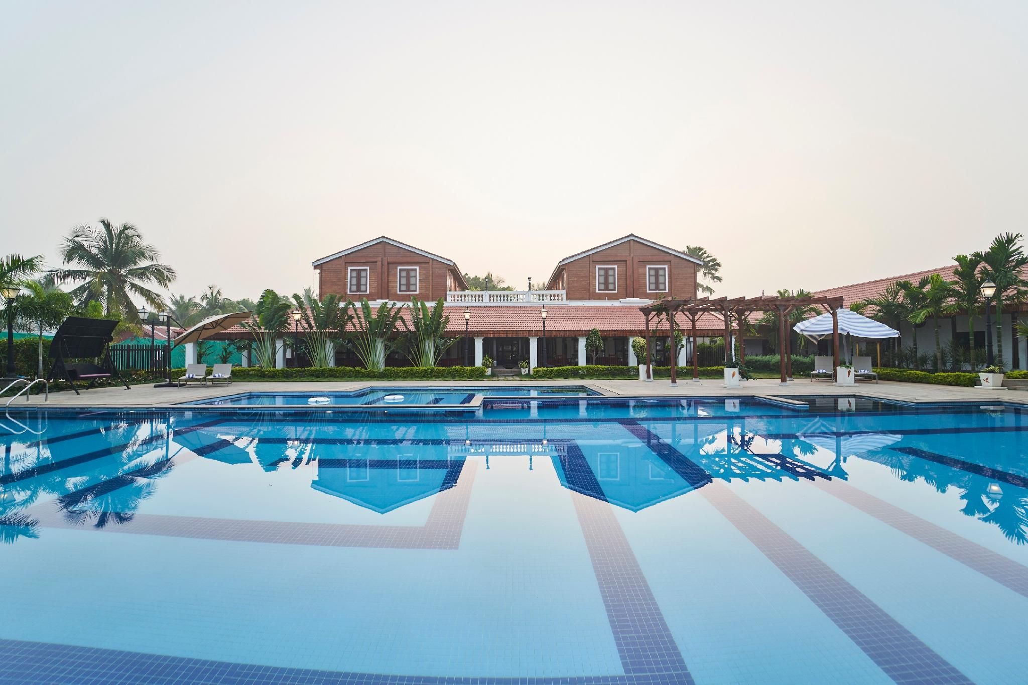 A swimming pool with a clear view of a two-story building in the background.