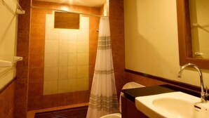 A bathroom with a shower, toilet, sink, and a mirror. - Wanathara Health Resort & Spa (Wang Thong)