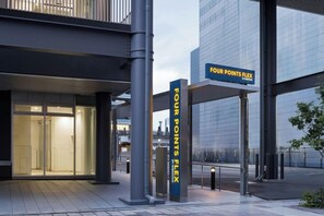 A building entrance with signage for 'FOUR POINTS FLEX' and a modern architectural design. - Unizo Inn Express Morioka (Morioka)