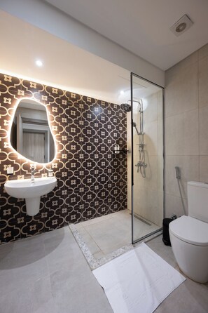 A modern bathroom with a glass shower enclosure, a white sink, and patterned wall tiles. - 88 by spacey  (cairo)