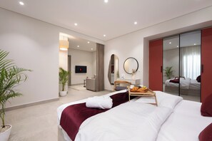 A modern hotel room with a large bed, a bedside table with a tray of breakfast, a mirror, and a TV. - 88 by spacey  (cairo)