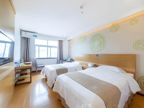 A hotel room with two beds, a desk, a chair, a TV, and a window with curtains. - Greentree Inn Xuancheng Jingxian Wannan First Street Express Hotel (Xuancheng)