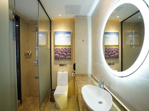 A modern bathroom with a glass shower enclosure, a toilet, a sink, and a large mirror. - Lavande Hotel (Qingyuan)