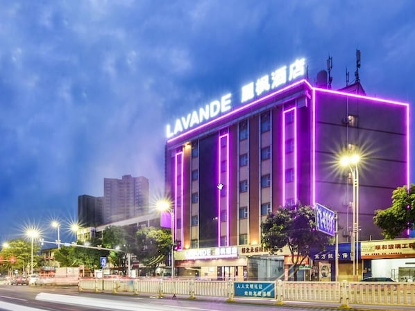 A hotel with a prominent sign, multiple floors, and a modern architectural design. - Lavande Hotel (Qingyuan)
