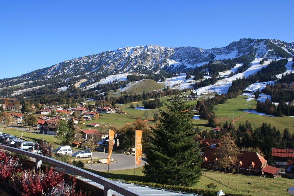 A mountain landscape with a small village and a bridge.