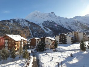 A snow-covered mountain resort with chalet-style buildings, a ski slope, and a clear sky. - L'Orée 12 Appartement/Fewo 4-Bettwohnung by Interhome (Saas-Fee)