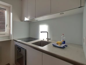 A kitchen with a sink, stove, and a window. - L'Orée 12 Appartement/Fewo 4-Bettwohnung by Interhome (Saas-Fee)