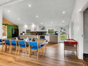 A spacious kitchen with a dining area, wooden flooring, and a view of the outdoors. - "Nahuel" - 300m to the fjord by Interhome (Vinderup)