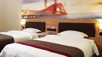 A hotel room with two beds, a mural of a bridge, and a wooden headboard.