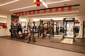 A gym with various exercise equipment, including weight machines and free weights.