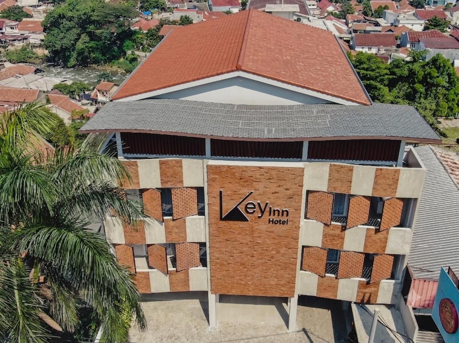 A hotel with a distinctive architectural design, featuring a prominent logo and a modern facade.