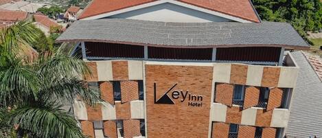 A hotel with a distinctive architectural design, featuring a prominent logo and a modern facade.