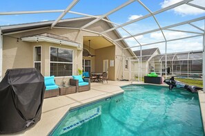 A covered outdoor area with a pool, seating, and a greenhouse structure. - Tivoli Manor Retreat | Cozy Florida Getaway (Davenport)