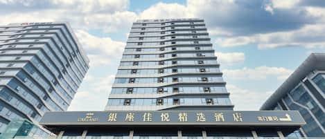 A high-rise building with a prominent sign in the foreground.