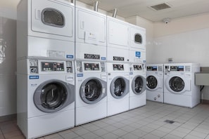 A row of stacked laundry machines in a public facility. - Reflections Holiday Parks Jimmys Beach (Hawks Nest)