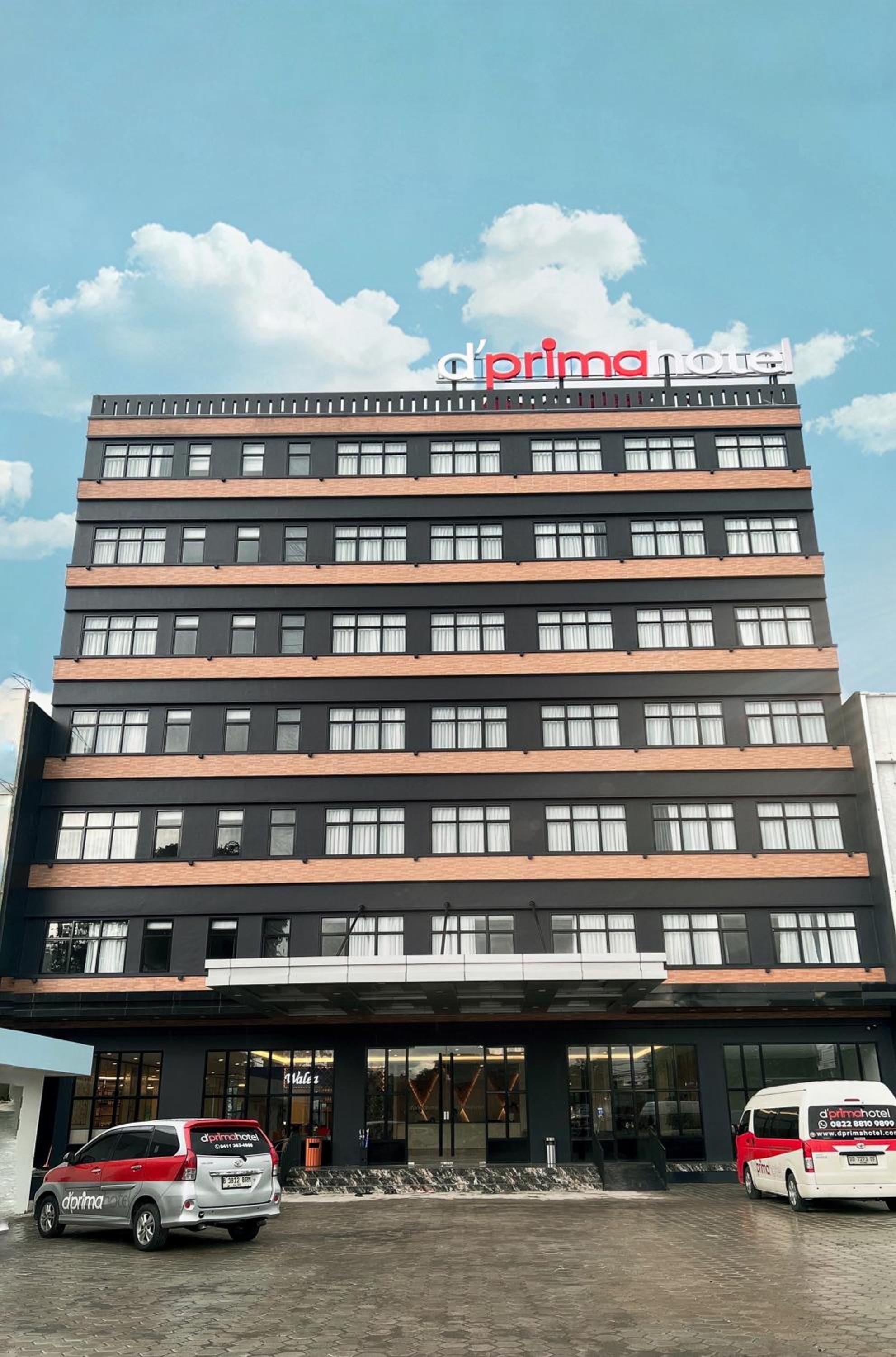 A multi-story building with a sign reading 'd'prima hotel' at the top.