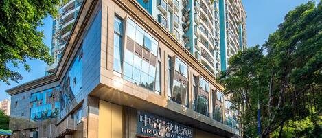 A hotel with a modern facade, large windows, and a prominent entrance.