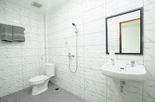A bathroom with a toilet, a sink, and a shower.