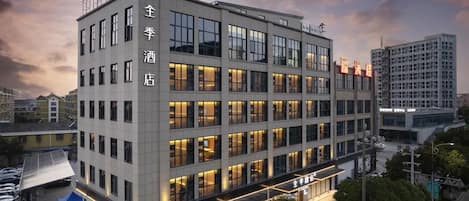 A multi-story hotel building with a modern facade, large windows, and a flat roof.