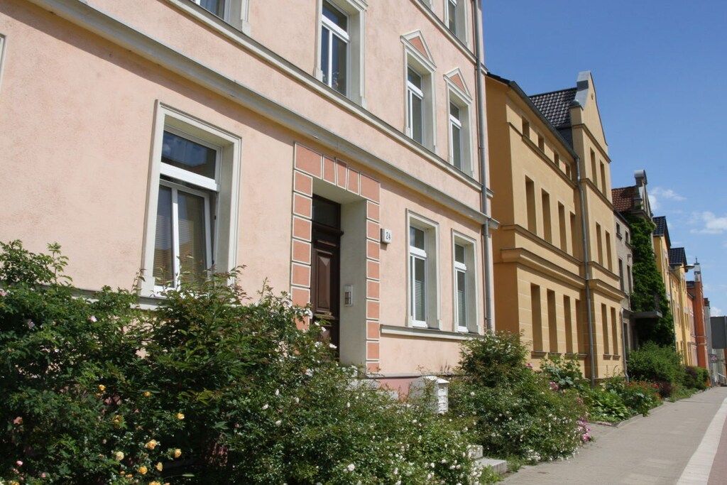 A row of traditional European-style buildings with a clear sky.