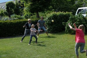 A group of people playing with a ball in a grassy outdoor area. - Located directly on the Drau reservoir (Feistritz i.R.)