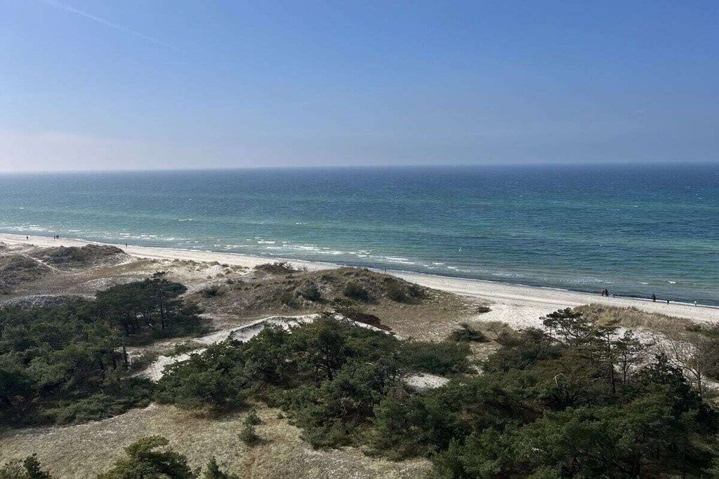 A beach with a clear view of the ocean and a sandy path.