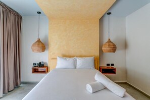 A hotel room with a large bed, two bedside tables, and a hanging light fixture. - Luxury & Serenity 2bd apt retreat, 1 km from beach (tulum)