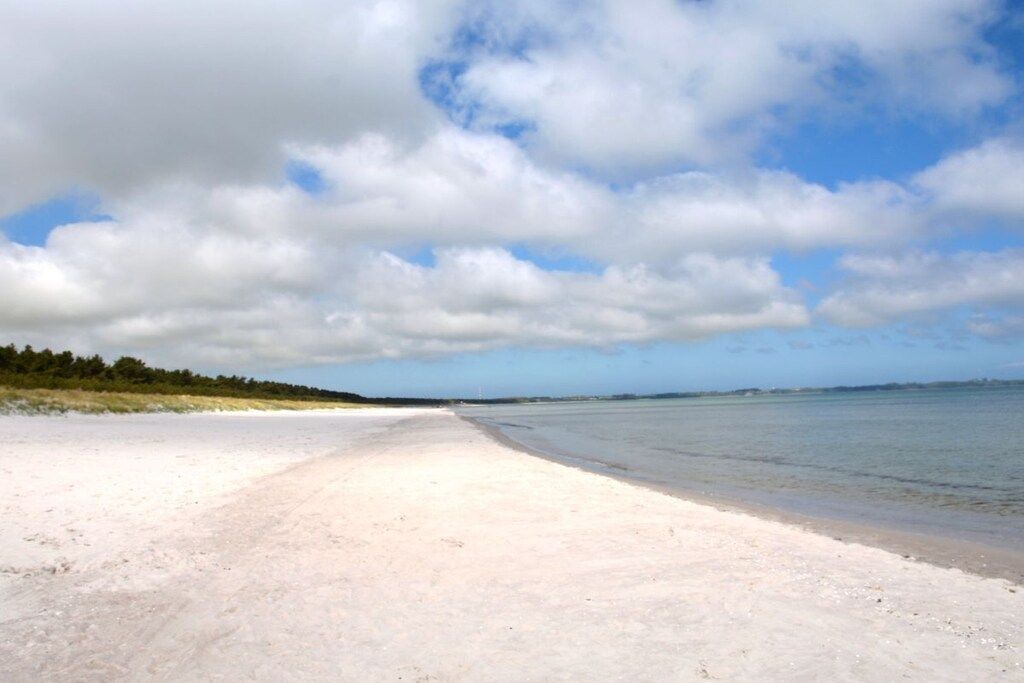 A beach with a sandy shore and a clear sky.