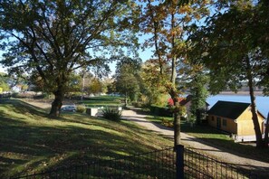 A residential area with a pathway leading to a house by a body of water. - Holiday home with lake view (Rheinsberg)