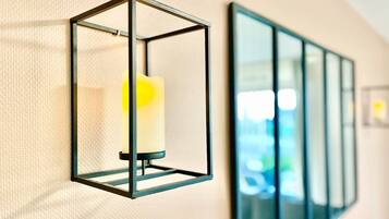 A wall-mounted light fixture with a candle inside.