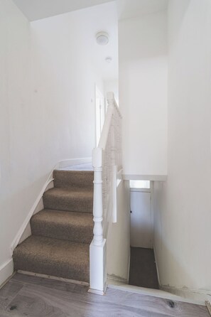 A staircase with carpeted steps leading to a landing. - 2 Bed| Sleeps 6|2 min Central line tube|Abba Arena (Greater London)