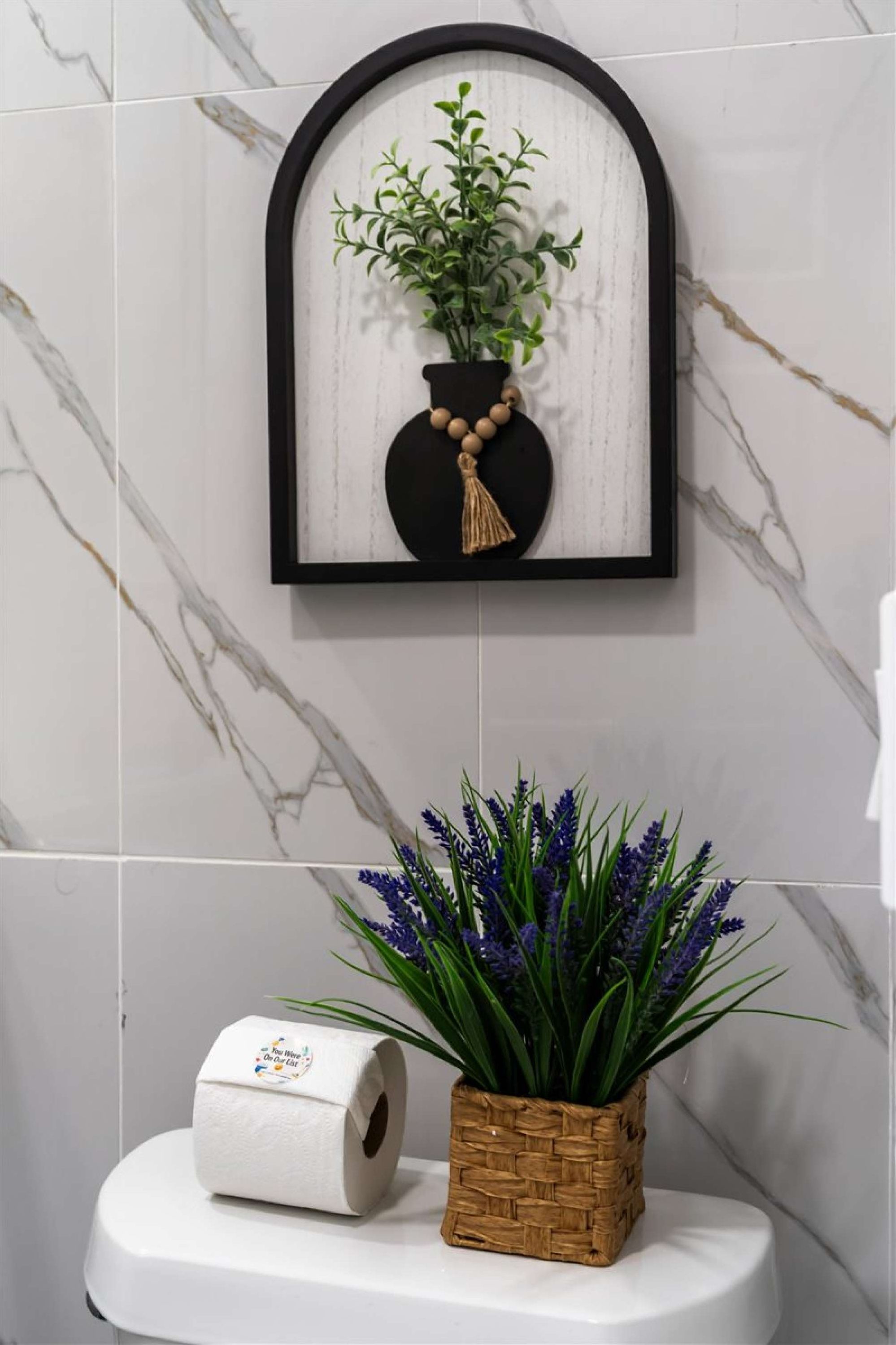 Bathroom 1: Clean marble tile and thoughtful finishes throughout.