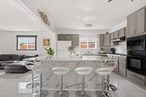Stainless steel appliances including a double wall oven.
