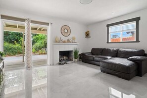 Curl up by the fireplace in the second living room.