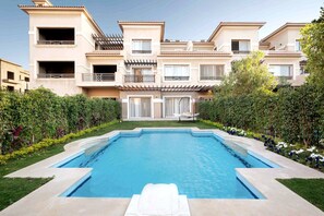 A residential building with a swimming pool, balconies, and a garden area. - Auja Residence Katemeya Dunes (New Cairo)