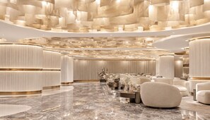 A luxurious lobby with a marble floor, plush seating, and a modern ceiling design. - Canvas Hotel Pattaya (Pattaya)