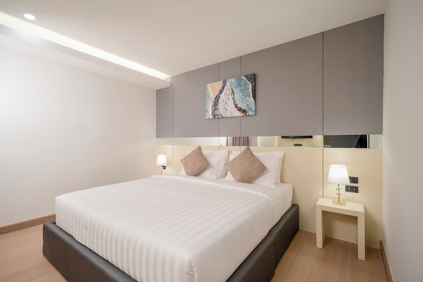 A modern hotel room with a large bed, two bedside tables, and a wall-mounted artwork. - Canvas Hotel Pattaya (Pattaya)