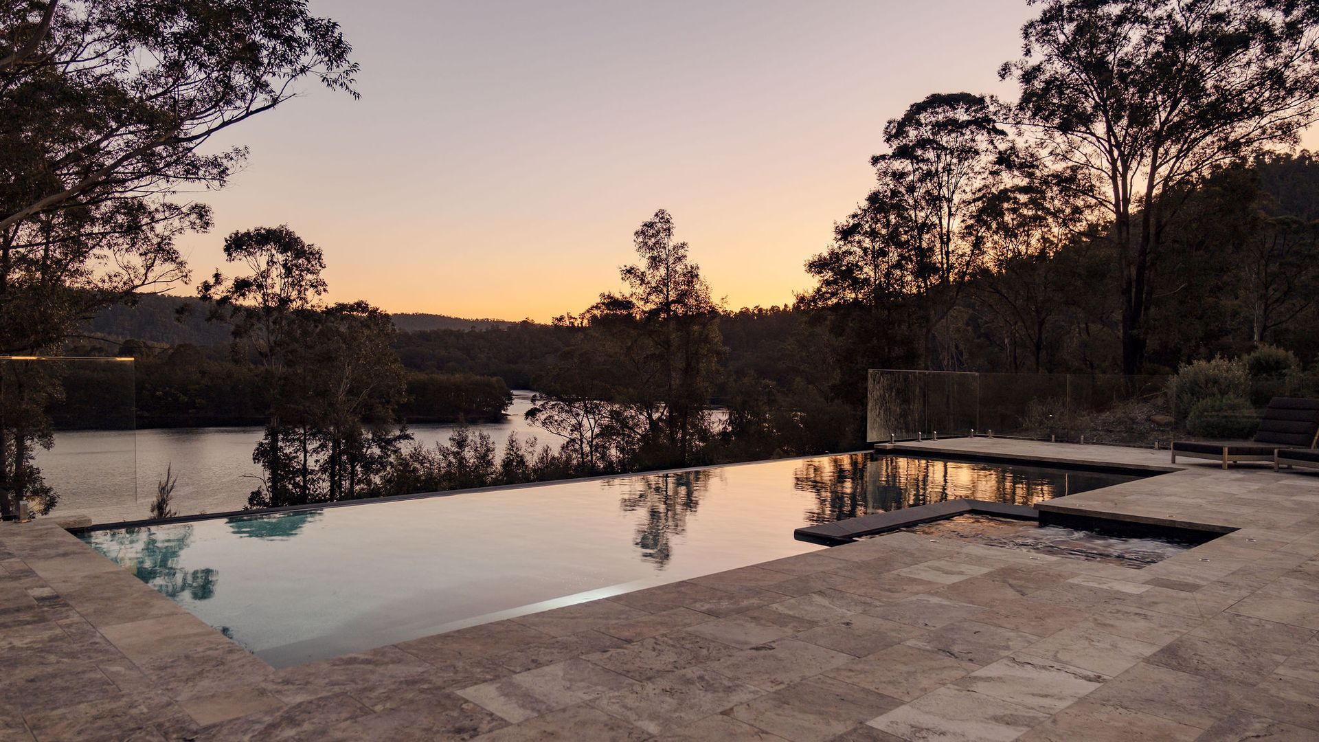 Una piscina con vistas despejadas del paisaje y los árboles circundantes.