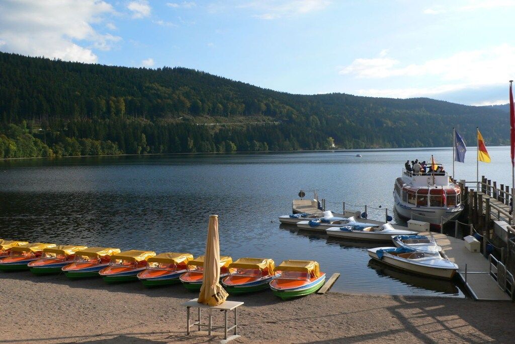 A lakeside dock with boats and a pier.