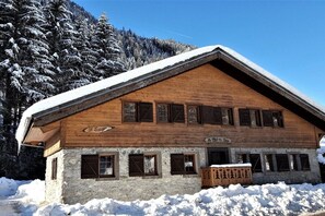 A wooden chalet with a stone foundation, multiple windows, and a sign indicating it is a mountain lodge. - Alpine hut in CHATEL with barbecue (CHATEL)