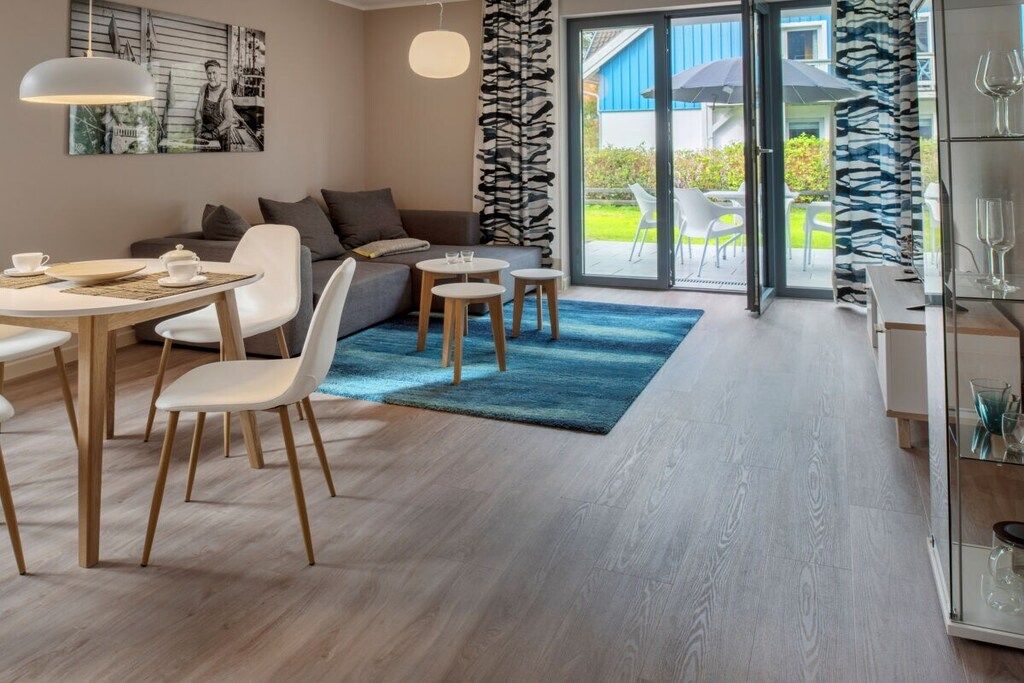 A modern living room with a dining area, a sofa, and a coffee table.