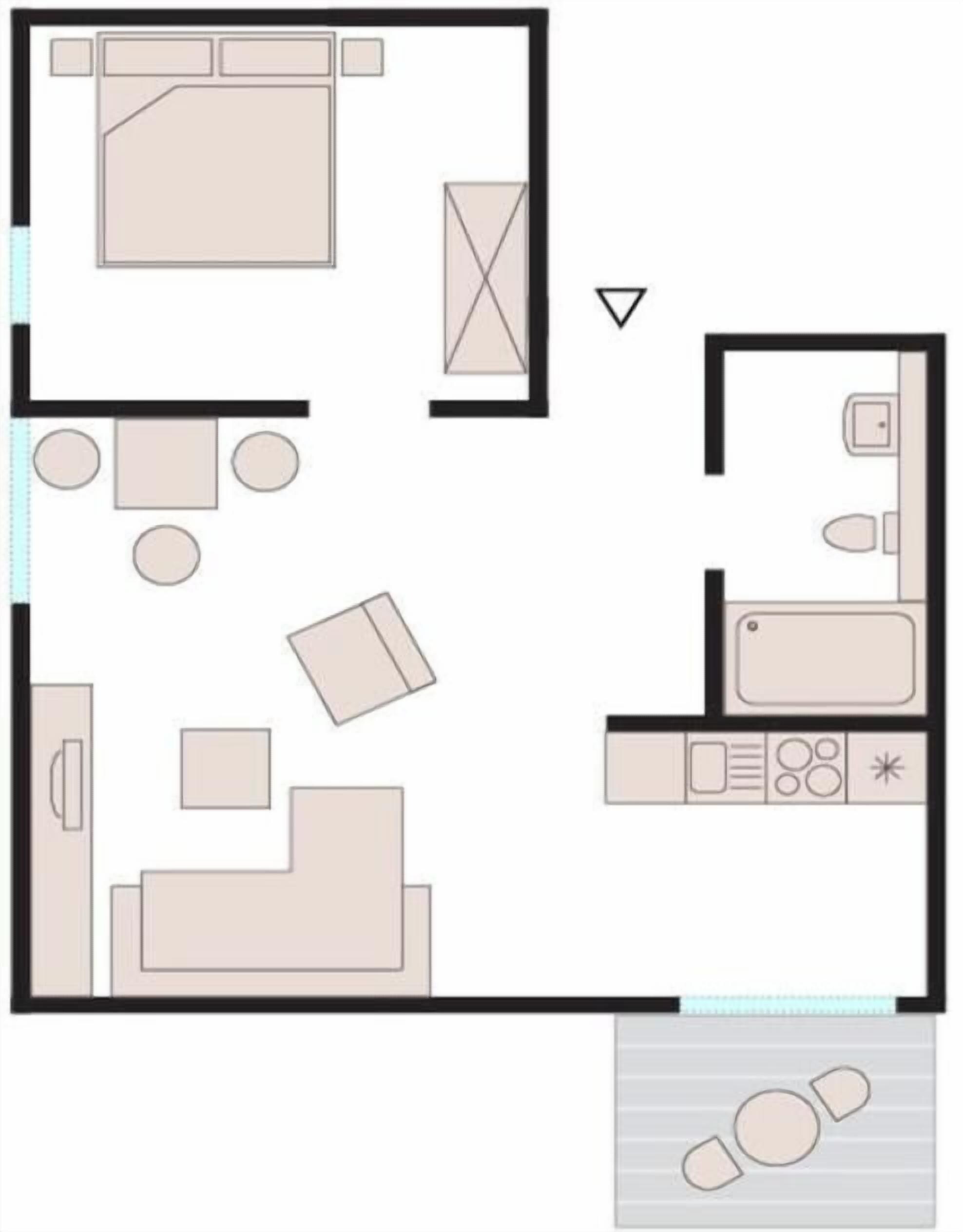 A hotel room layout with a bed, seating area, kitchenette, and bathroom.