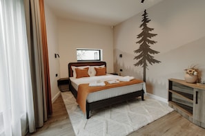 Un dormitorio con cama, mesita de noche, cómoda, ventana y un mural en la pared.