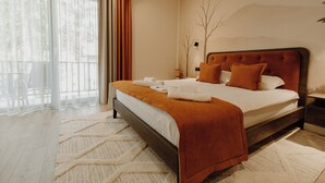 A neatly made bed with a brown headboard, white bedding, and a brown throw blanket. - Arbor Hotel (Sovata)