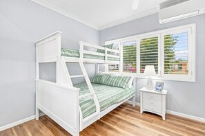 A bunk bed with a view of the outdoors through a window with blinds. - HiTide at Toogoom | Stunning Views | Air-Con | Beach Access | Linens | Pets (Toogoom)